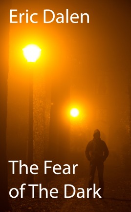 Man alone standing in the middle of a lane on a foggy night.
